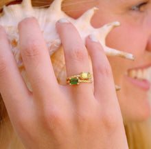 Load image into Gallery viewer, Our signature-ring is a simple, elegant, classic one with a twist, literally! The twisted band with a bright and colorful gemstone makes a lovely present for a loved one or a well deserved treat for yourself. You can wear our Twisted Rings solo, but try to mix, switch, match or stack them for endless combinations! Gemstones in this picture: Green tourmaline and Peridot.