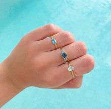 Load image into Gallery viewer, This one is a classic model but made modern with bright colorful gemstones.The big gemstone in the middle is an eye-catcher defined by the two sidestones. A beautiful statement piece! Choose two colors to personalize this classic piece of fine jewelry. You'll keep this three stones ring forever cause this one never goes out of style! Two shades of topaz in one beautiful ring.