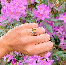 Load image into Gallery viewer, Our signature-ring is a simple, elegant, classic one with a twist, literally! The twisted band with a bright and colorful gemstone makes a lovely present for a loved one or a well deserved treat for yourself. You can wear our Twisted Rings solo, but try to mix, switch, match or stack them for endless combinations! Gemstones in this picture: Citrine, Sky Blue Topaz and Amethyst.