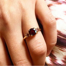 Load image into Gallery viewer, This one is a classic model but made modern with bright colorful gemstones.The big gemstone in the middle is an eye-catcher defined by the two sidestones. A beautiful statement piece! Choose two colors to personalize this classic piece of fine jewelry. You'll keep this three stones ring forever cause this one never goes out of style!  A beautiful garnet stone and two light pink tourmaline gemstones in a ring.