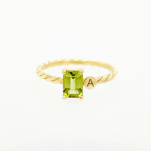 Load image into Gallery viewer, Jewelry with a special meaning is powerful, especially when it's personalized. Our twisted ring with one or two initials makes the perfect gift for your loved one. Gemstone in this picture: Peridot.