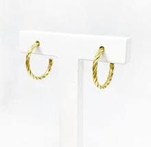 Load image into Gallery viewer,  Our hoop earrings gave a little twist to a classic must-have in your jewelry box. Such a good classic pair of 18k gold hoop earrings.
