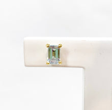 Load image into Gallery viewer, It&#39;s all in the details! Our studs are available in different colors. Choose your favorite colorful gemstone for that extra sparkle. Fine jewelry is fun and so are our studs. You can mix and match them with every other piece of our earring collection. Perfect as a first pair of earrings or small gift. Wear our studs individually or pared, it&#39;s up to you! Rectangle / Emerald Sky Blue Topaz earring studs.

