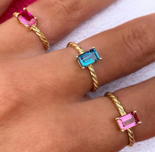 Load image into Gallery viewer, Our signature-ring is a simple, elegant, classic one with a twist, literally! The twisted band with a bright and colorful gemstone makes a lovely present for a loved one or a well deserved treat for yourself. You can wear our Twisted Rings solo, but try to mix, switch, match or stack them for endless combinations! Gemstones in this picture: Ruby, London Blue Topaz and Pink Tourmaline.
