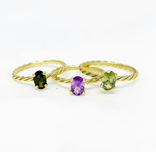 Load image into Gallery viewer, Our signature-ring is a simple, elegant, classic one with a twist, literally! The twisted band with a bright and colorful gemstone makes a lovely present for a loved one or a well deserved treat for yourself. You can wear our Twisted Rings solo, but try to mix, switch, match or stack them for endless combinations! Gemstones in this picture: Green Tourmaline, Amethyst and Peridot.
