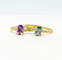 Load image into Gallery viewer, Our signature-ring is a simple, elegant, classic one with a twist, literally! The twisted band with a bright and colorful gemstone makes a lovely present for a loved one or a well deserved treat for yourself. You can wear our Twisted Rings solo, but try to mix, switch, match or stack them for endless combinations! Gemstones in this picture: Amethyst and London Blue Topaz.
