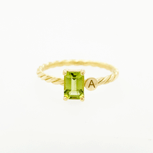 Load image into Gallery viewer, Jewelry with a special meaning is powerful, especially when it&#39;s personalized. Our twisted ring with one or two initials makes the perfect gift for your loved one. Gemstone in this picture: Peridot.
